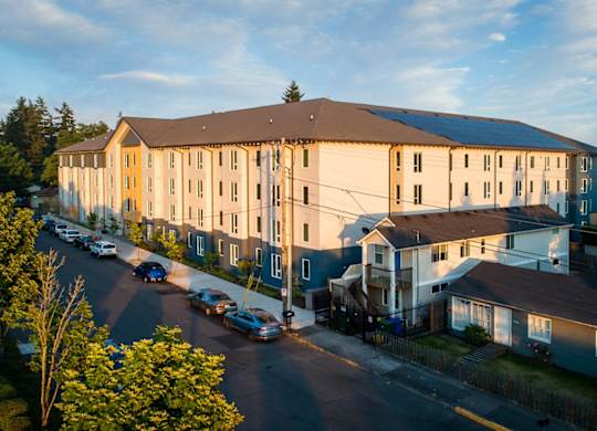 A large building with a parking lot in front of it.
