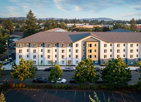 A large building with a parking lot in front of it.