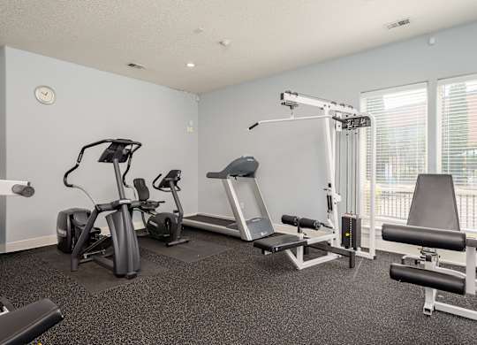 A well equipped gym with a variety of exercise equipment.