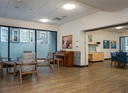 A room with wooden floors and furniture.
