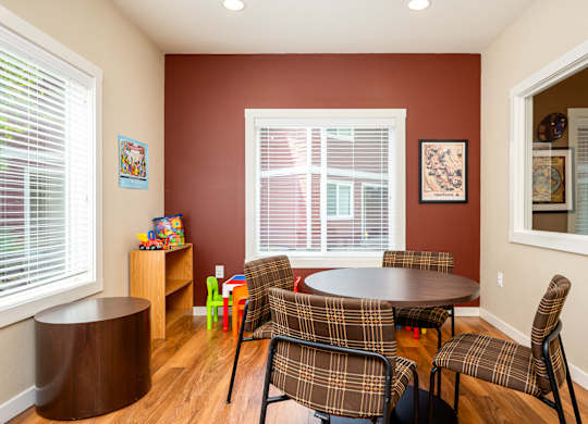 A room with a table and chairs.