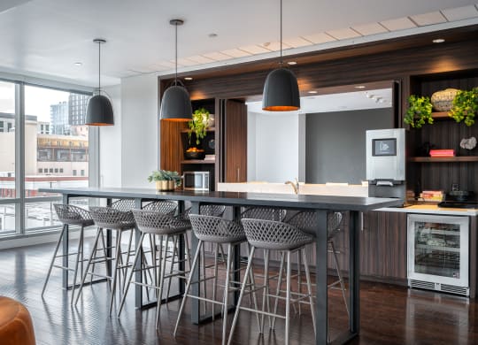 a kitchen with a large island with bar stools and chairs