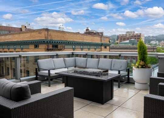 a terrace with couches and a table on a balcony