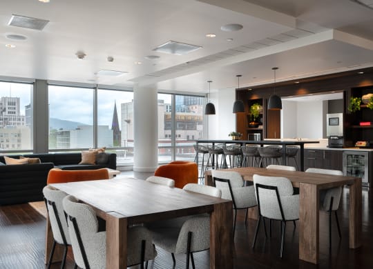 a dining room with a table and chairs and a kitchen with a large window