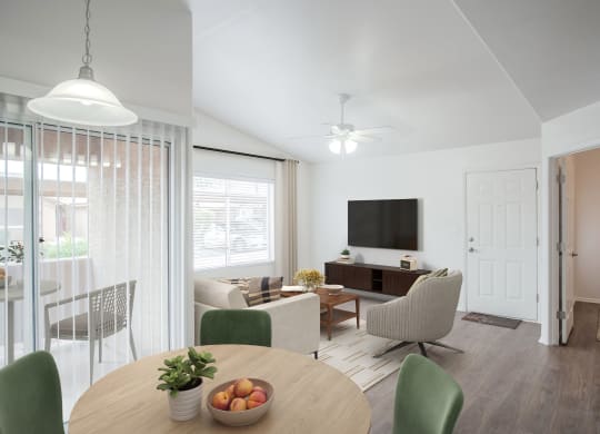 a living room and dining room with a table and chairs