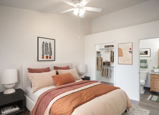 a bedroom with a large bed and a bathroom with a toilet