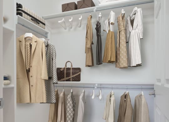 a closet with a rack of clothes in it