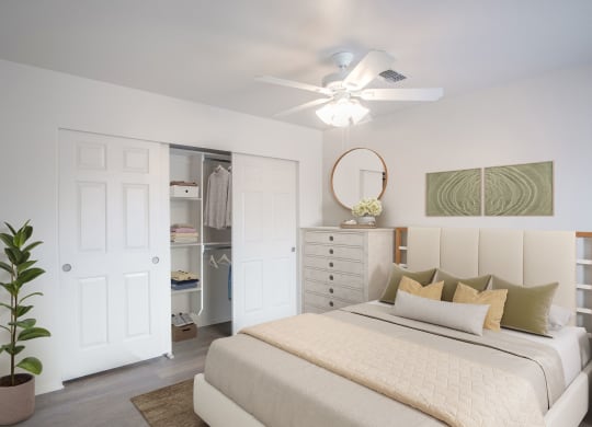a bedroom with a bed and a ceiling fan