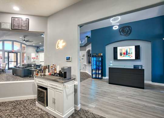 A modern living room with a white kitchen island and a television.