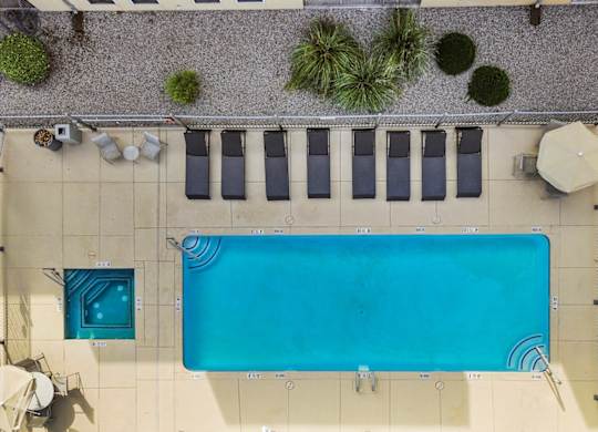 A rectangular pool with a blue tiled border and a white tiled floor.