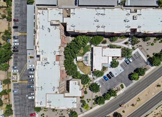 An aerial view of a parking lot and buildings.