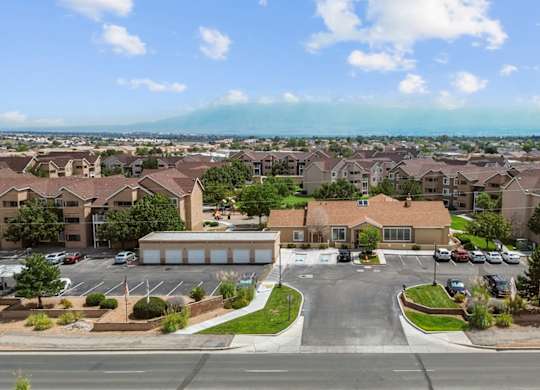 A view of a residential area with houses and a parking lot.