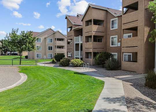 Apartment complex with a green lawn in front.
