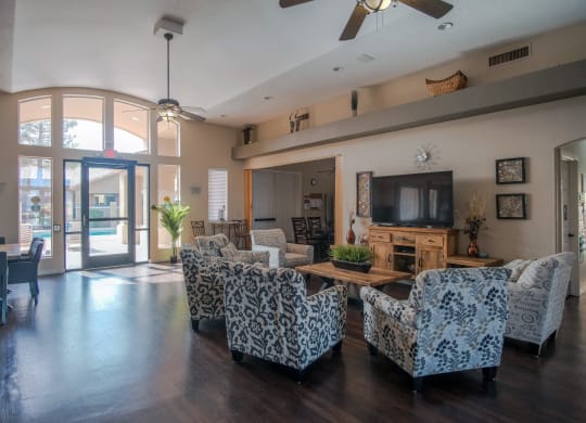 a living room with couches and chairs and a television