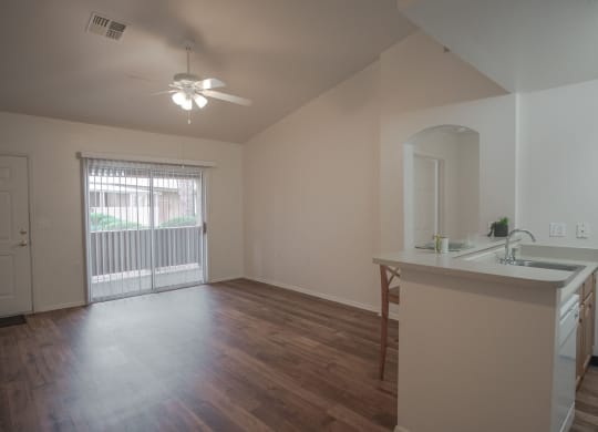 an empty living room and kitchen in an empty house