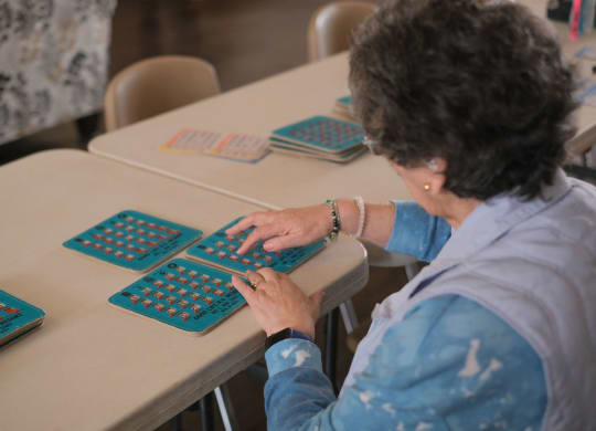 a woman sitting at a desk typing on a computer keyboard