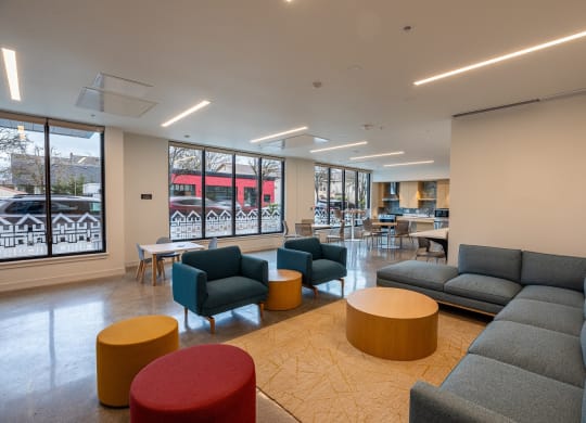 a lounge area with couches and chairs and tables in a lobby