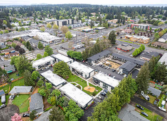 A bird's eye view of a small town with a mix of residential and commercial buildings.