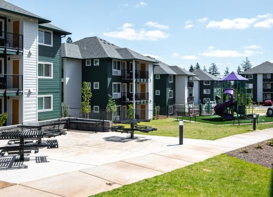 an image of a playground in front of an apartment building