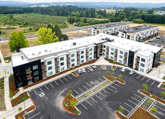 A parking lot in front of apartment buildings.