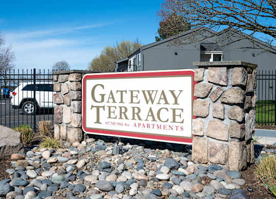 A sign for Gateway Terrace Apartments in front of a building.