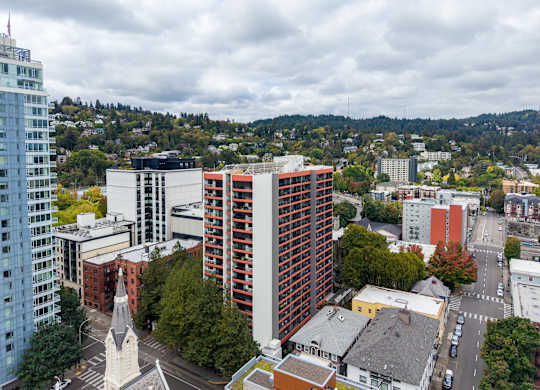 A cityscape with a church and a tall building in the foreground.
