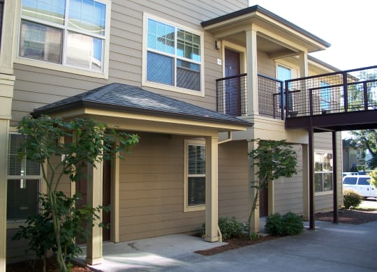 the front of the house has a walkway and a balcony