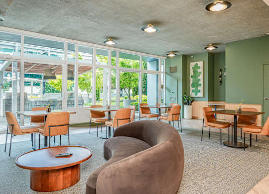 A room with a green wall and a table with chairs.