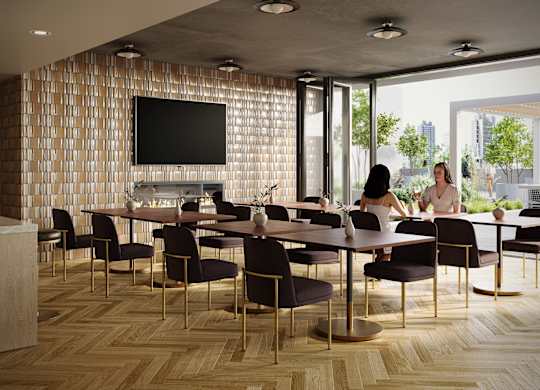 A conference room with a long table and chairs, a television on the wall, and a view of the city outside the windows.