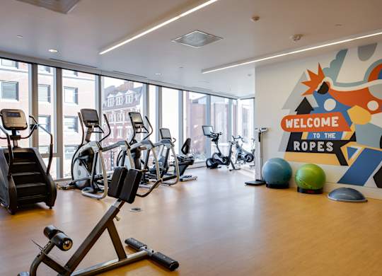 A gym with a sign that says "Welcome to the Ropes".