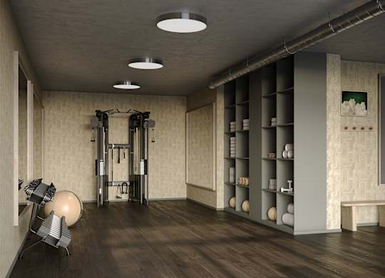 A gym with a weightlifting area and a bench.