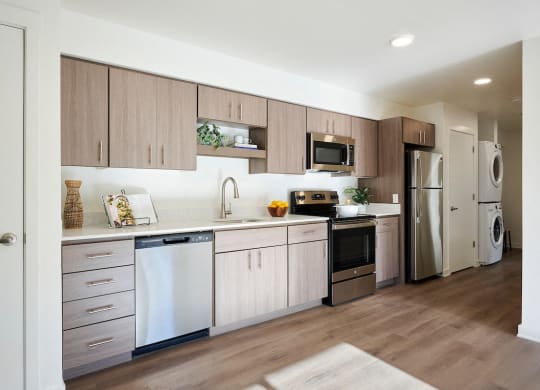 a kitchen with white cabinets and stainless steel appliances