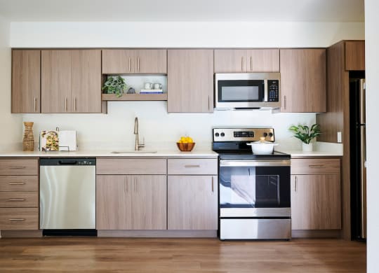 a kitchen with wooden cabinets and stainless steel appliances