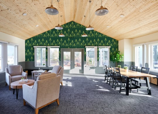 a large room with chairs tables and chairs and a wall covered in green wallpaper