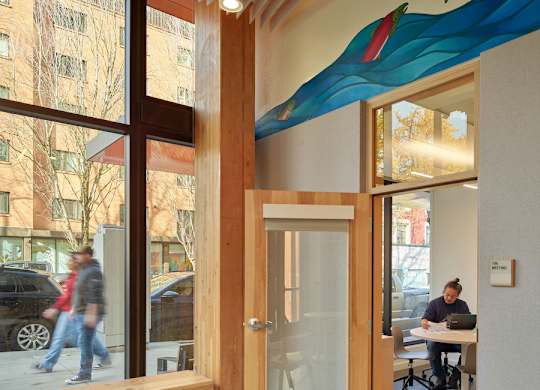 A room with a wooden ceiling and a mural of a fish on the wall.