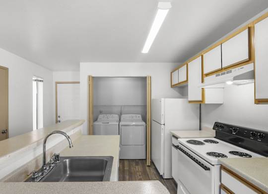 A kitchen with white appliances and a white countertop.