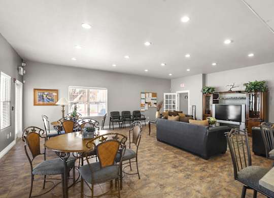 A spacious living room with a dining table and chairs.