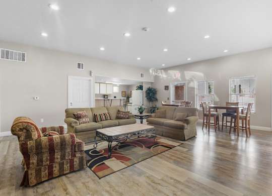 A living room with a sofa, armchair, and coffee table.