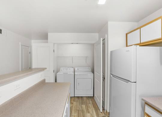 A white laundry room with a washer and dryer.