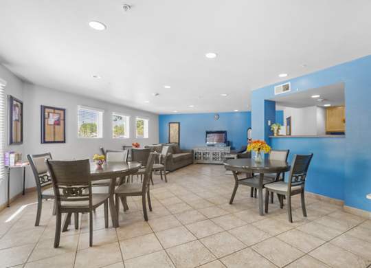 A dining room with a table set for six.