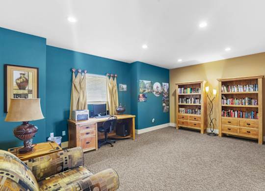 A room with a blue wall and a bookshelf.