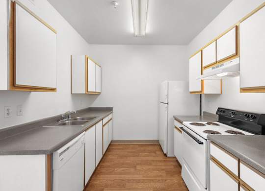 A kitchen with white cabinets and a black stove top oven.