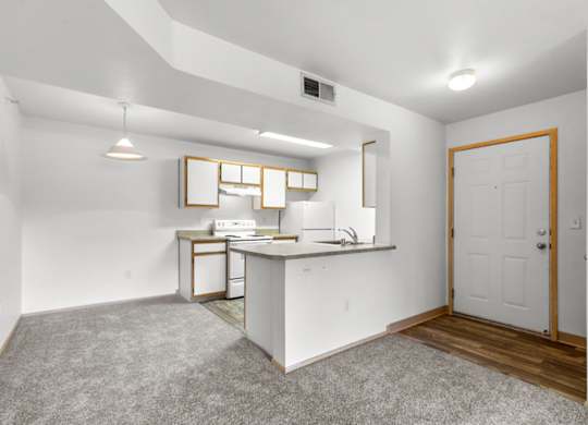 A small kitchen with white appliances and a white countertop.