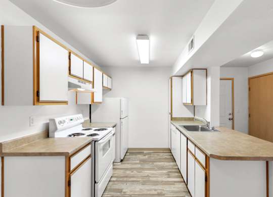 A kitchen with white appliances and wooden cabinets.