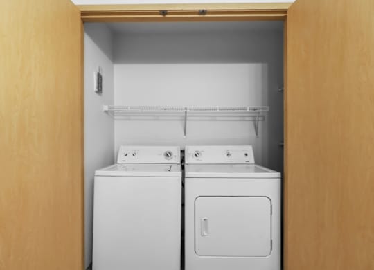 A small laundry room with a washer and dryer.