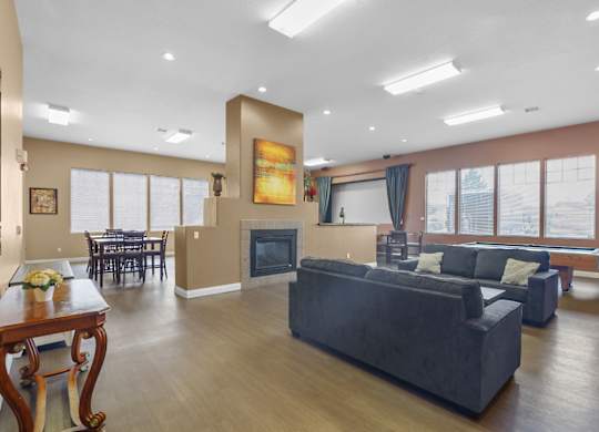 A living room with a grey couch and a wooden table.
