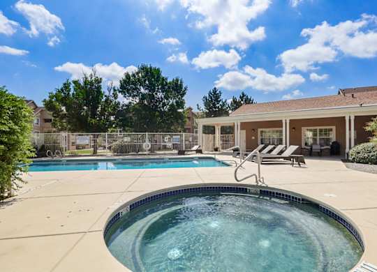 A hot tub sits in the middle of a patio.
