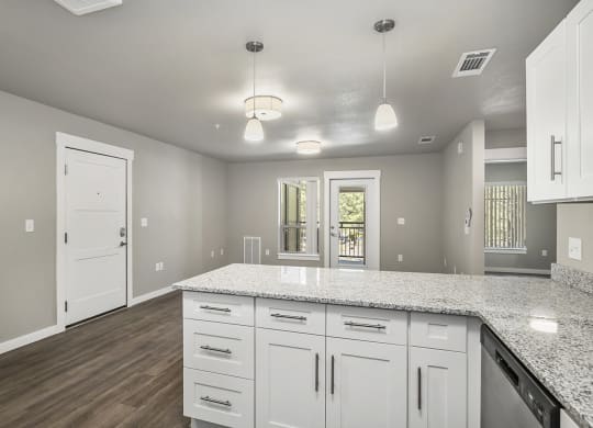 a large kitchen with white cabinets and stainless steel appliances
