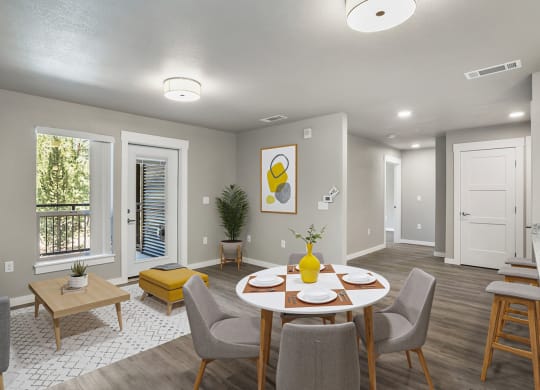 an open living room and dining room with a table and chairs