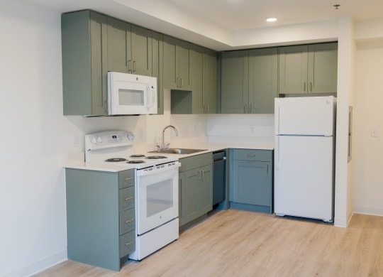 a kitchen with white appliances and blue and white cabinets